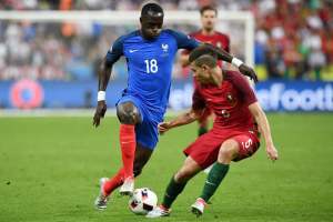France's midfielder Moussa Sissoko (L) vies for the ball against Portugal's defender Raphael Guerreiro during the Euro 2016 final football match between France and Portugal at the Stade de France in Saint-Denis, north of Paris, on July 10, 2016. / AFP PHOTO / FRANCK FIFEFRANCK FIFE/AFP/Getty Images